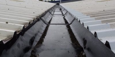 Image showing cut edge corrosion on metal roof sheeting and corrosion being fixed on the right hand side