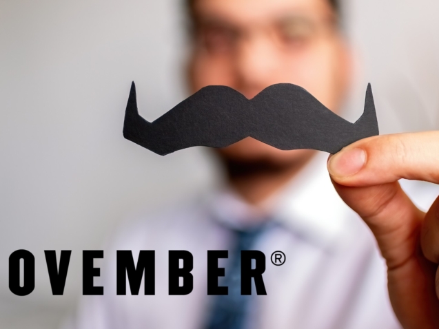 Blurred out man with a Movember moustache with the offical Movember logo